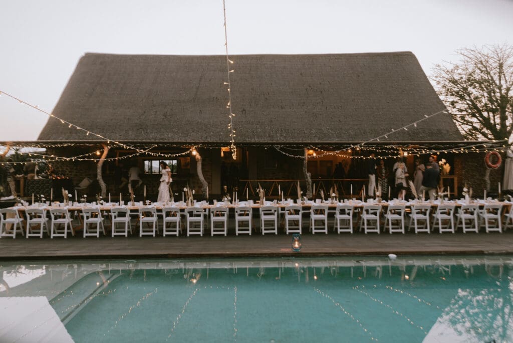 Wedding reception at bush lodge with tables set up around pool deck