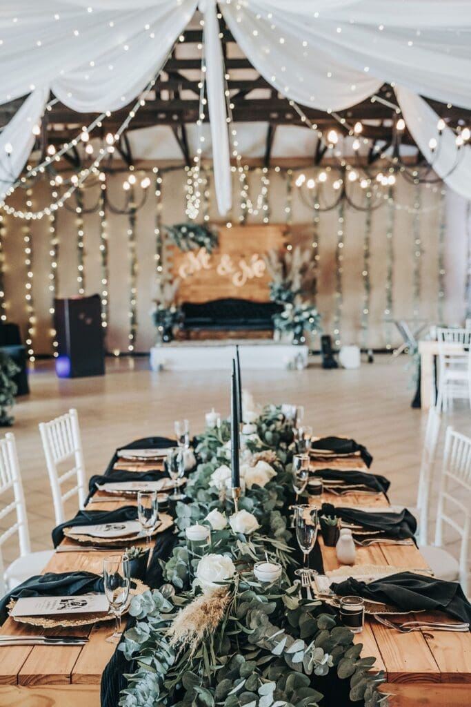 Focused shot of forest green and white table decor inside Eden Lassie reception venue