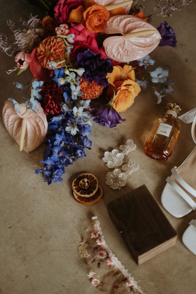 Flay lay photo of vibrant bouquet and bridal details