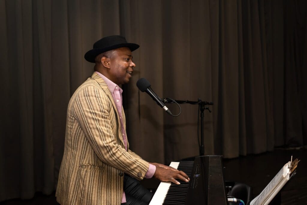 Man singing and playing keyboard