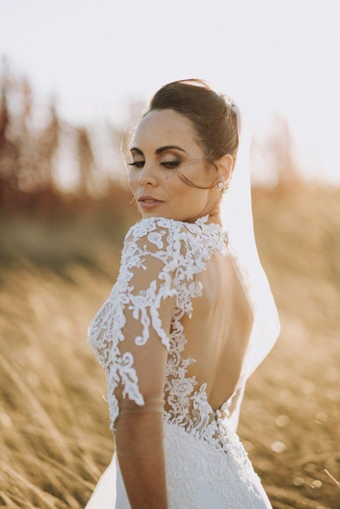 Bride standing in golden field