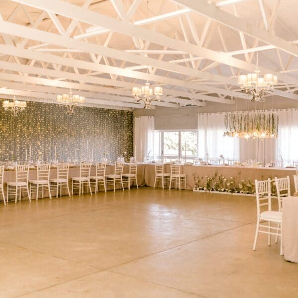 Sophisticated wedding reception venue with exposed white roof beams