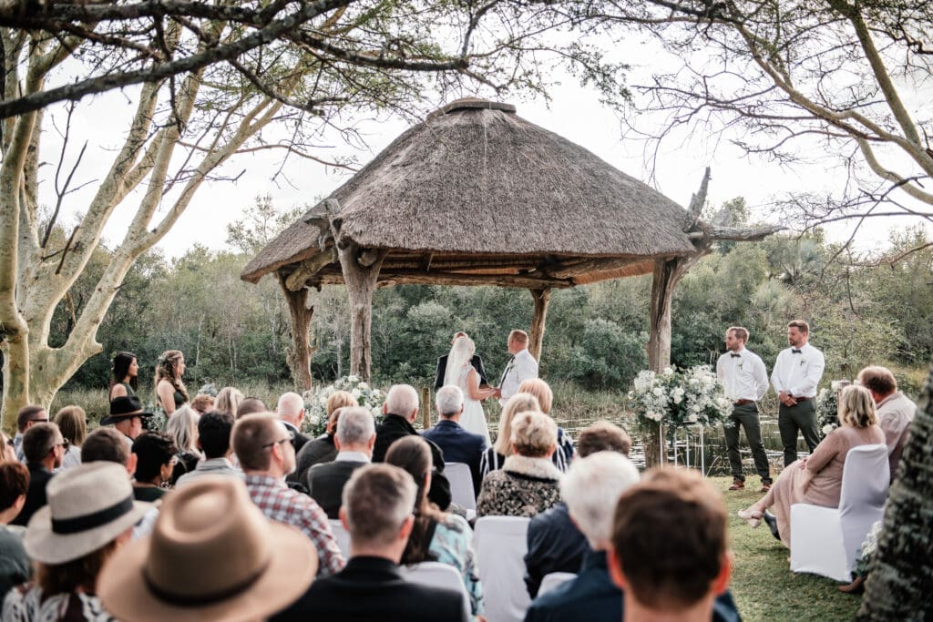 Wedding ceremony at Bonamanzi beside water's edge