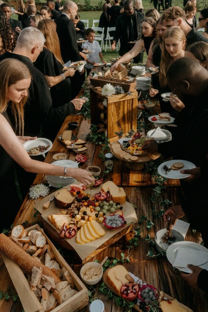 People standing around canape station loading up their plates