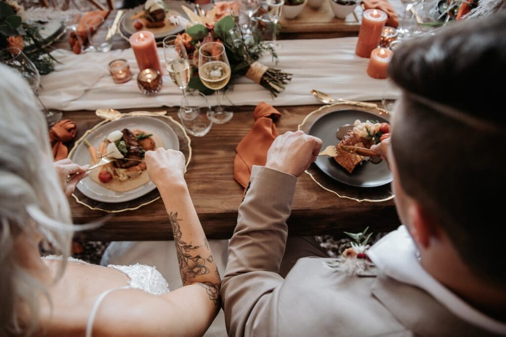 Bride and groom eating reception dinner prepared by Hamblin's Catering