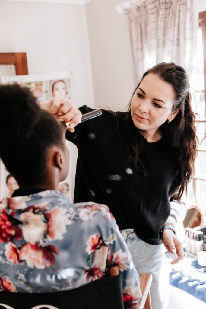 Make-up artist applying powder to bride