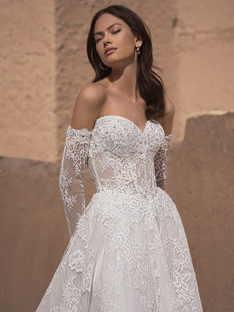 Strapless and delicately detailed lace wedding gown with separate lace sleeves