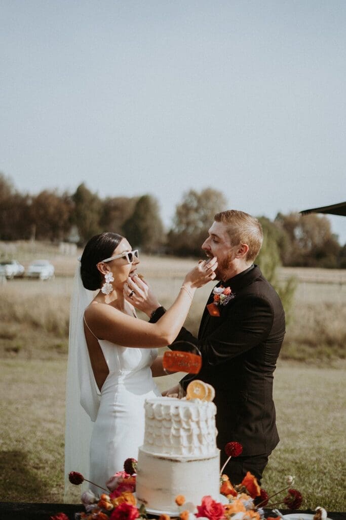 Bridal couple tasting wedding cake
