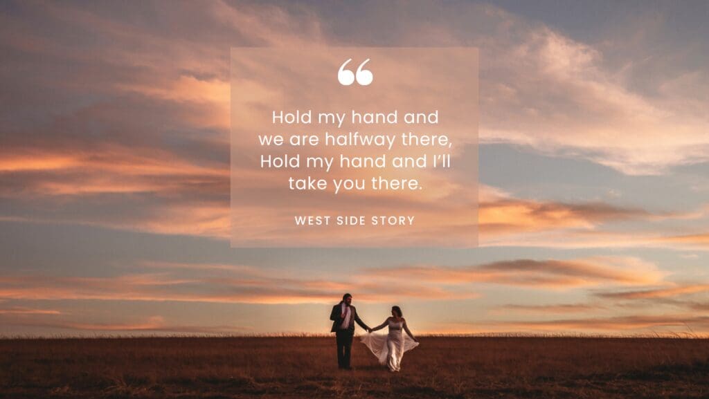 Bride and groom walking hand in hand at sunset