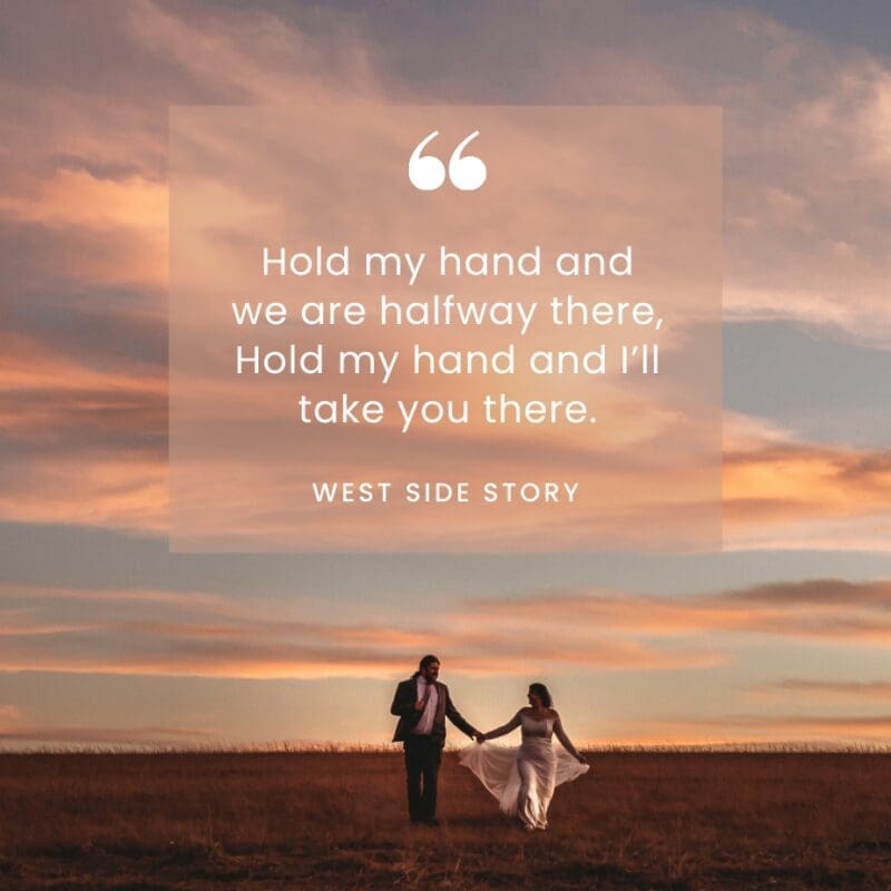 Bride and groom walking hand in hand at sunset