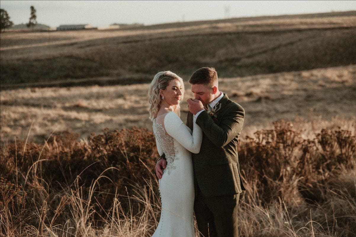 Groom kisses bride's hand