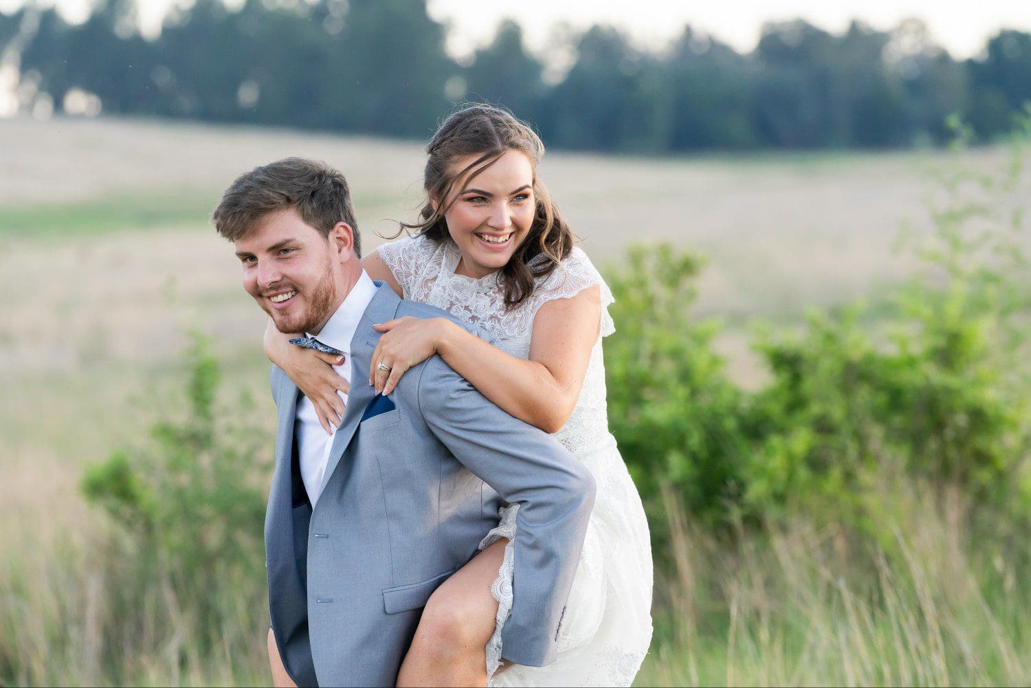 Groom gives bride a piggyback
