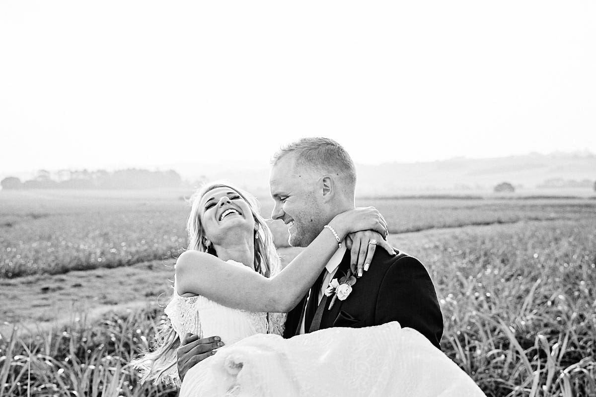Groom carries bride 