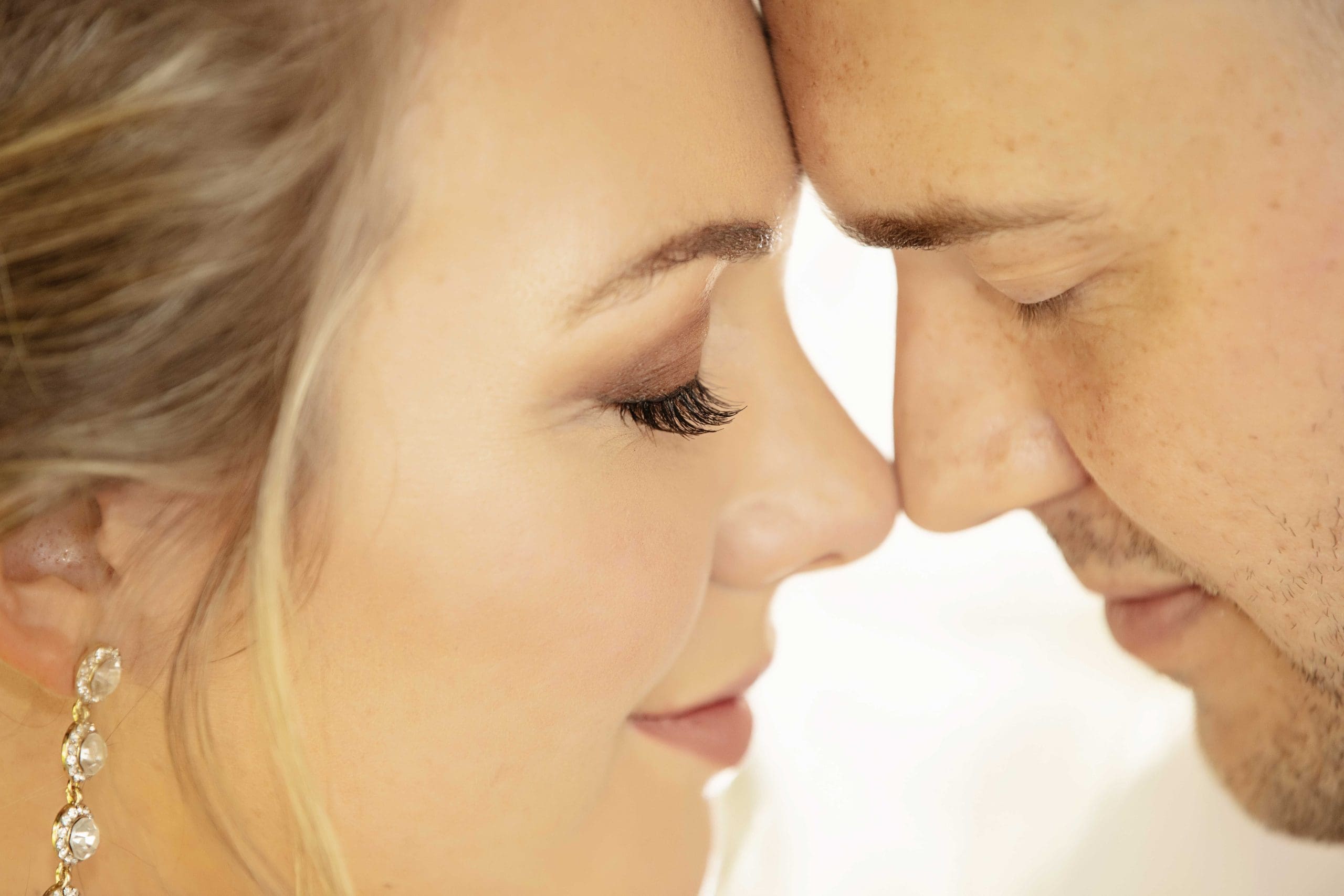 Delicate nose to nose shot of bridal couple