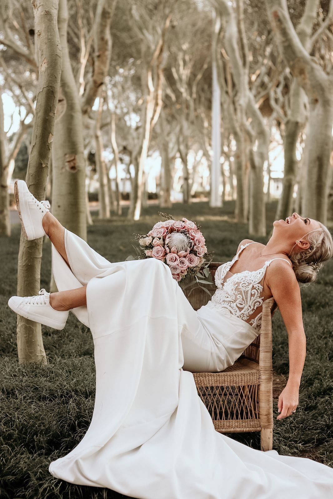 Bride wearing sneakers with wedding dress