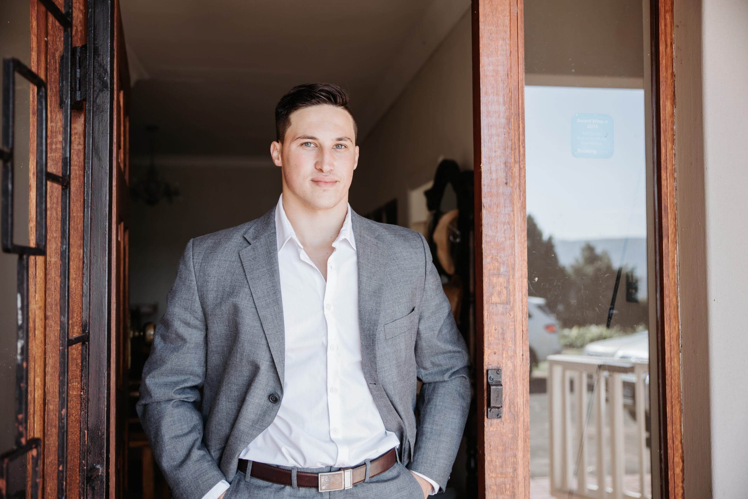 Grey suit and brown belt for groom