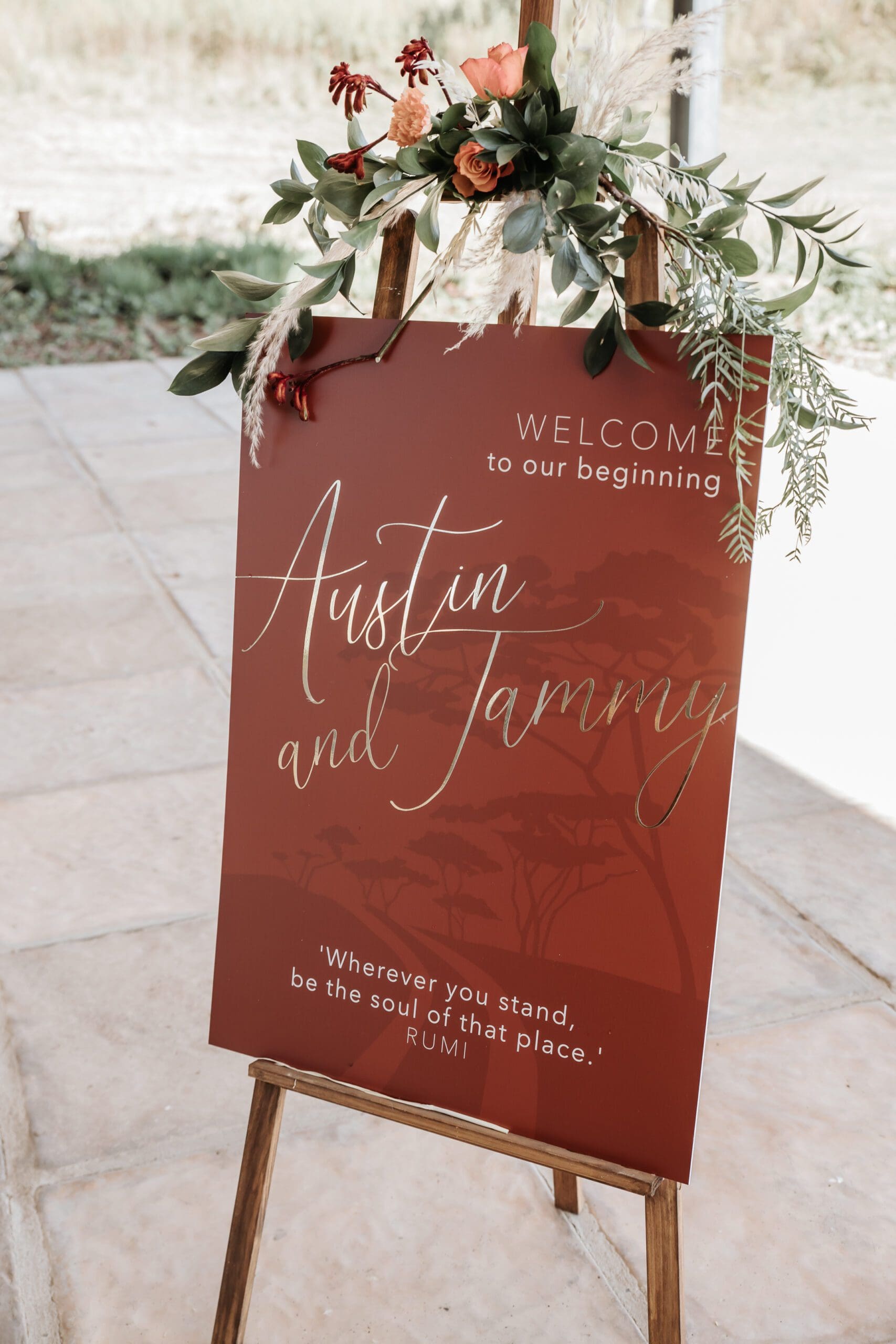 Rust coloured welcome board at wedding