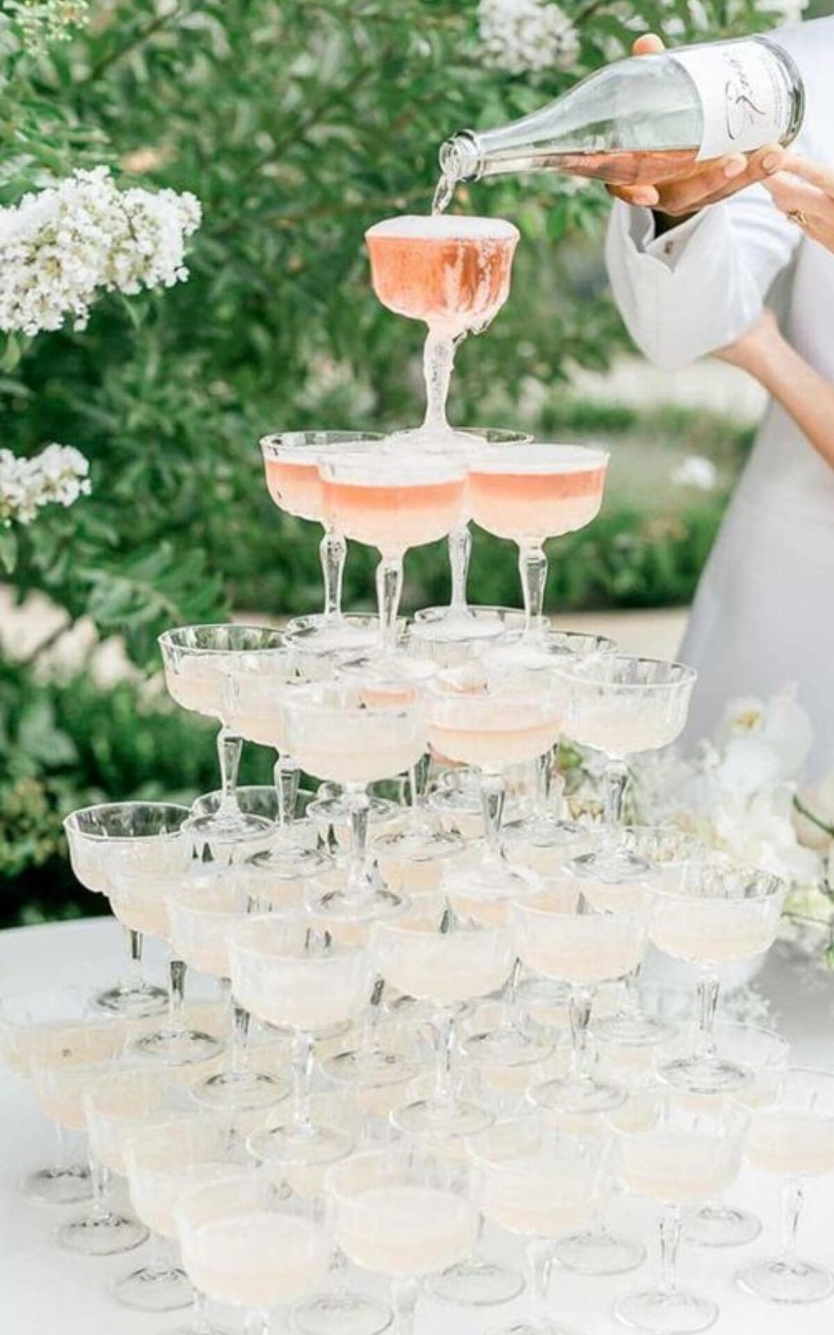 Bride and groom pouring champagne tower