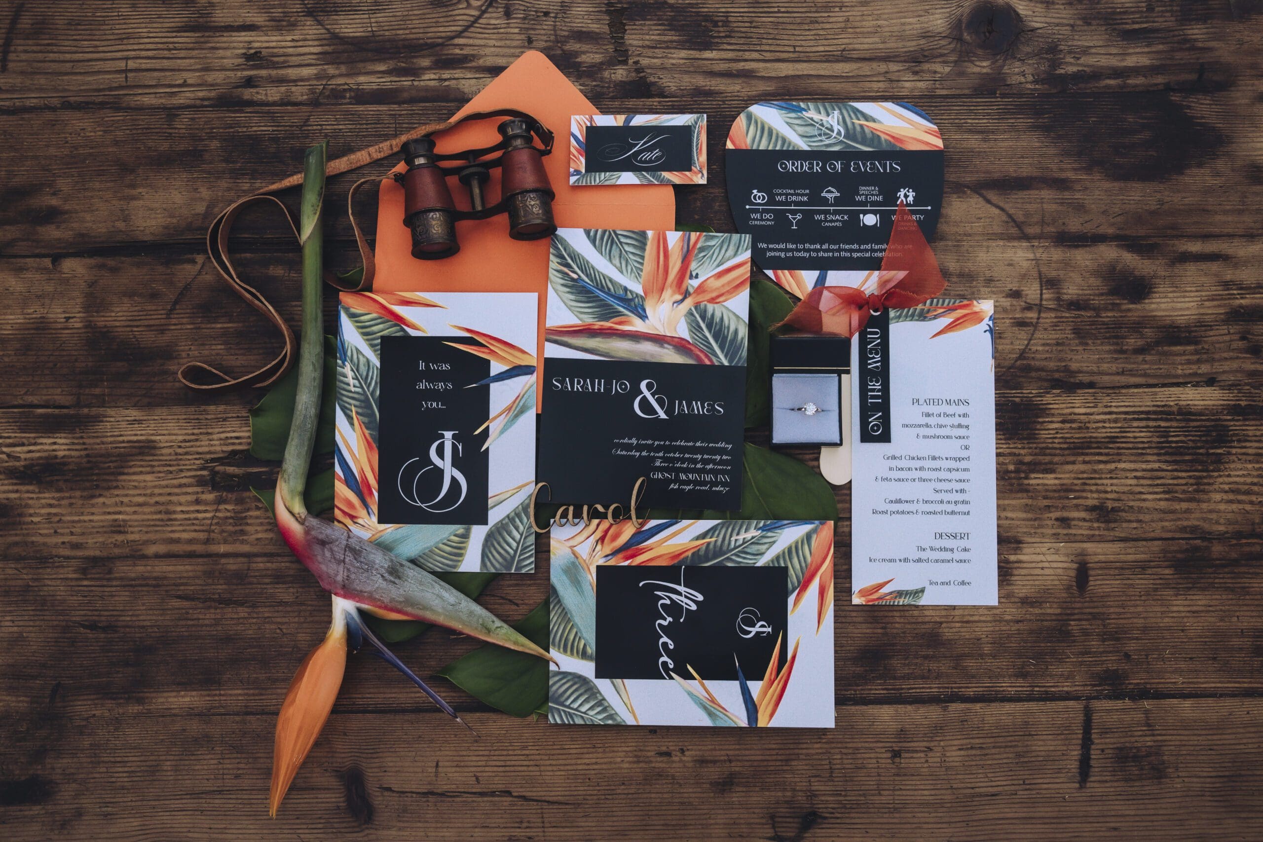 Bold colourful orange and green wedding stationery flat lay