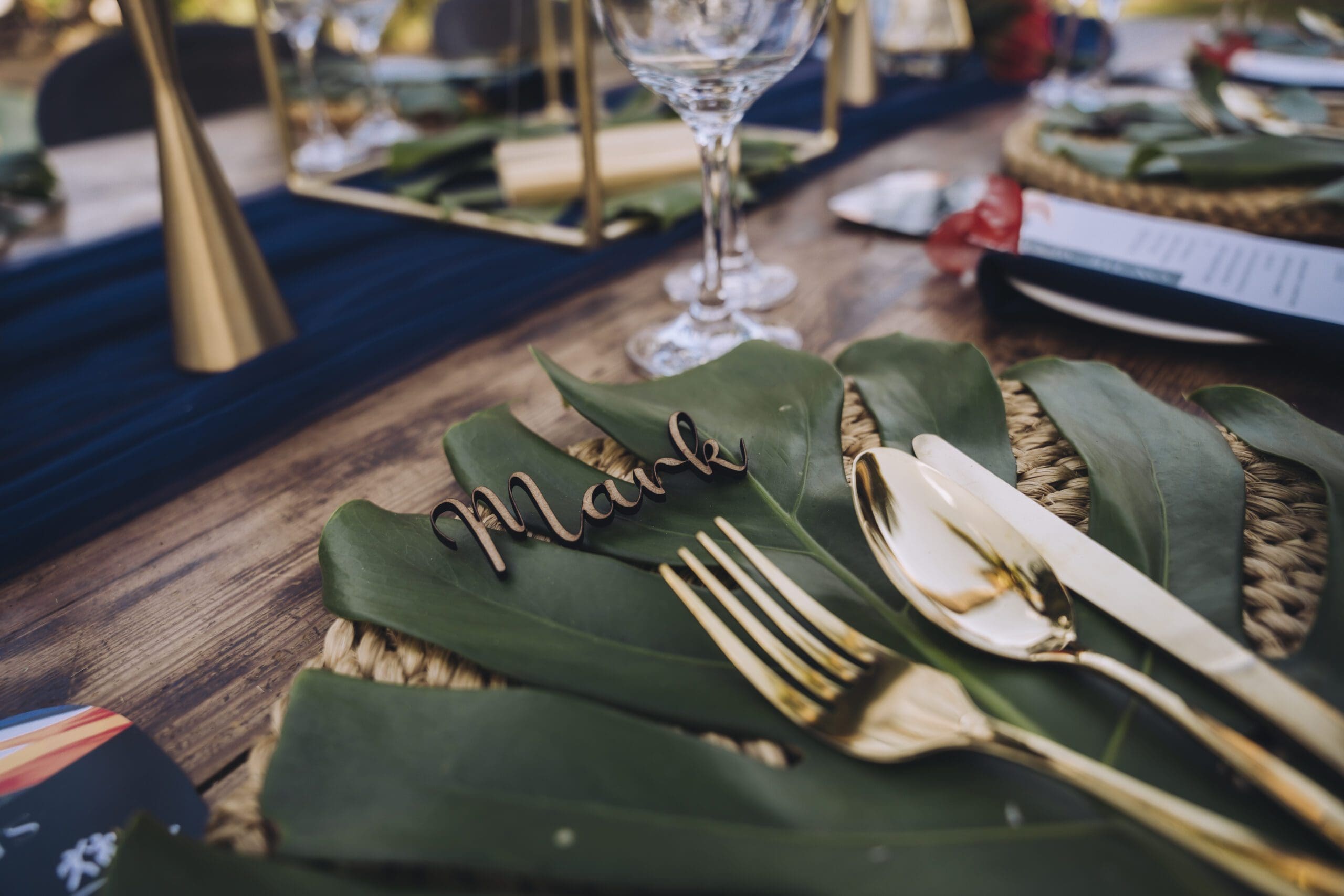 Laser cut name in wood on tropical green leaf