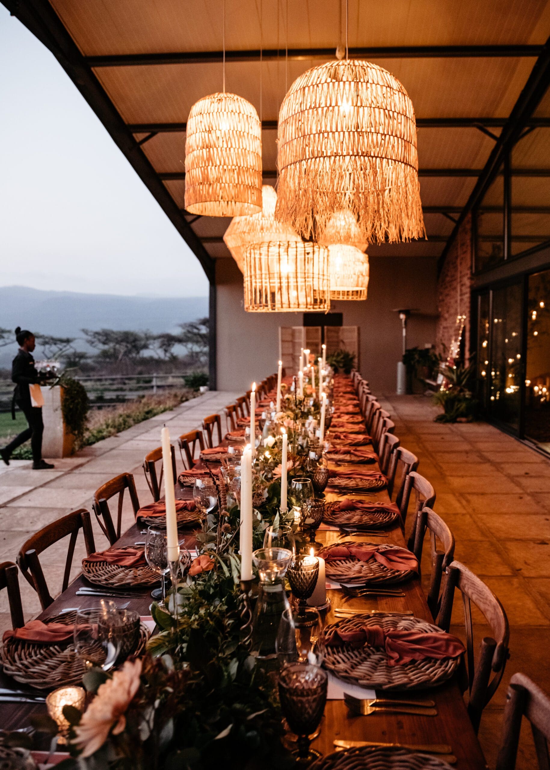 Woven basket lights suspended above beautifully set table