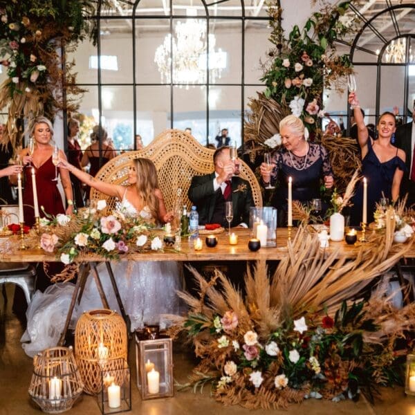 Bridal main table with flowers and candles and enormous floor to ceiling mirrors