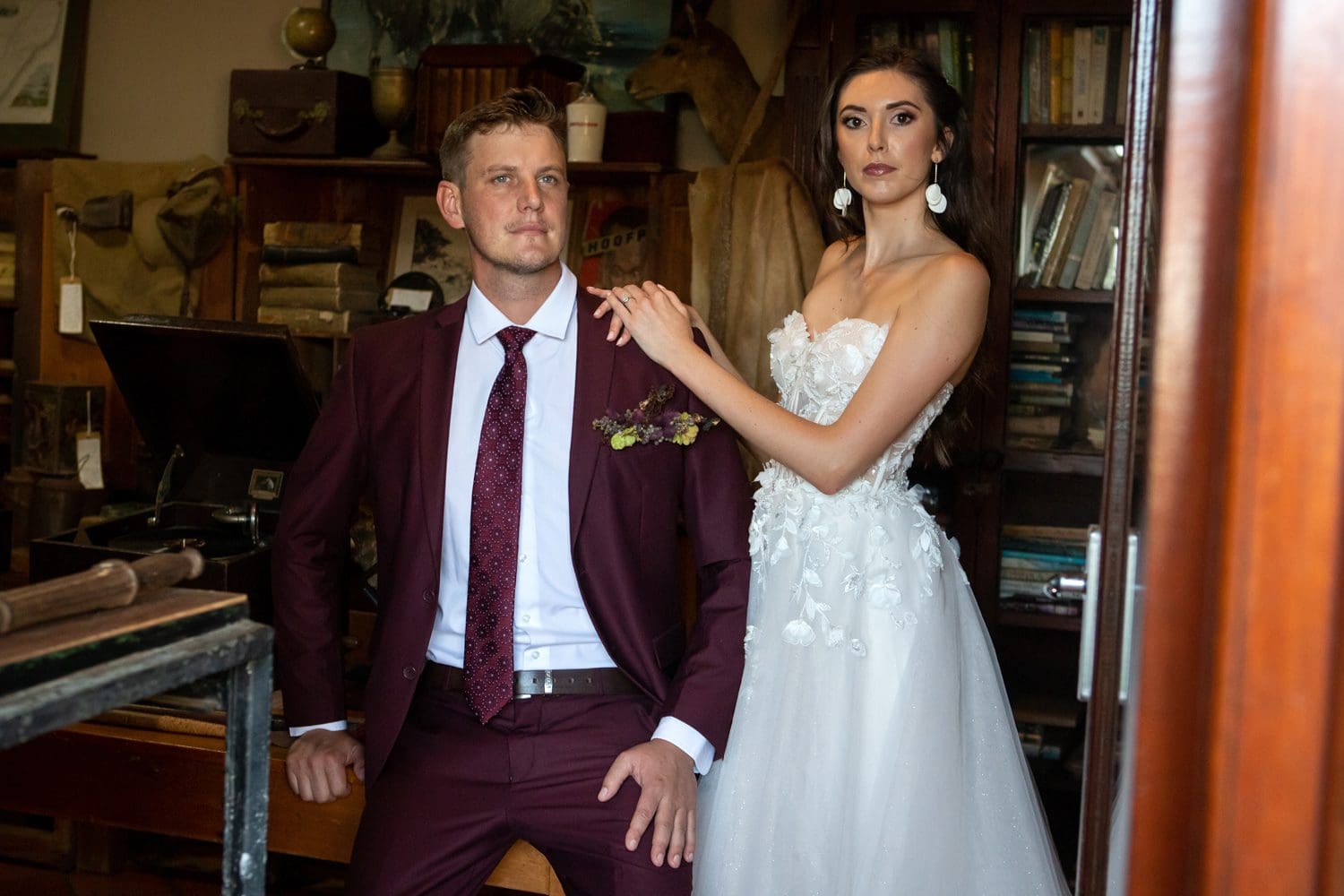 Bride in 3D Floral Lace Dress and Groom in Burgundy Suit