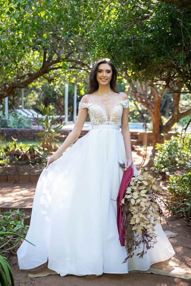 Bride wearing off the shoulder wedding dress