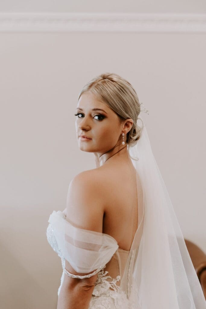 Bride with natural make-up and hair up in an elegant bun