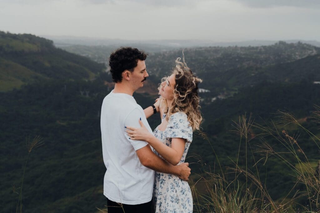 Couple shoot on hillside on a windy day