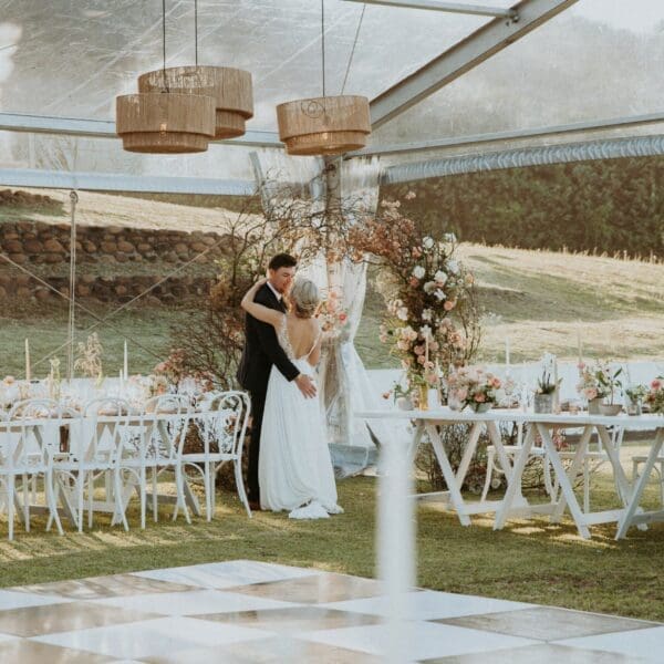 Bride and groom exploring their elegant reception marquee
