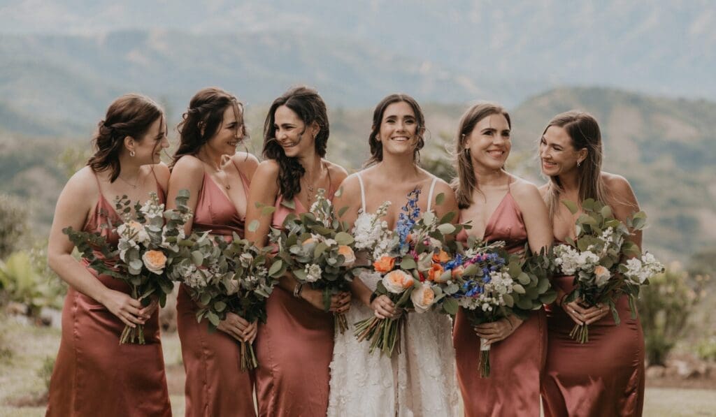 Bride and bridesmaids holding vibrant colourful wedding bouquets