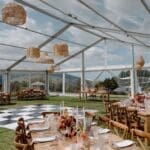 Glass marquee on manicured lawns with black and white dance floor