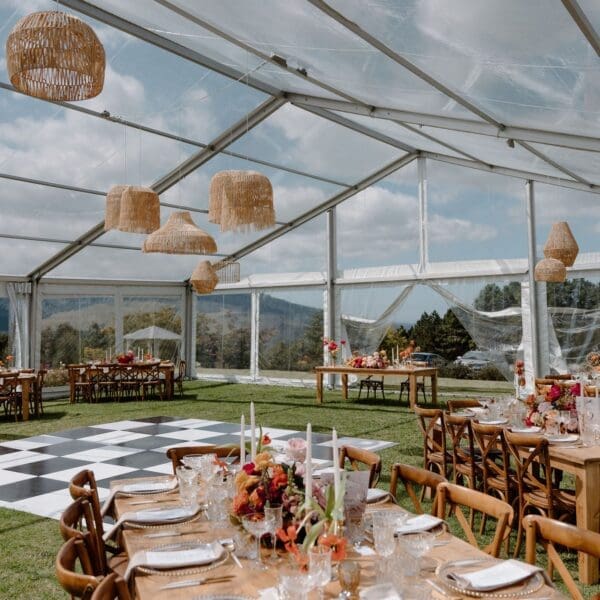 Glass marquee on manicured lawns with black and white dance floor