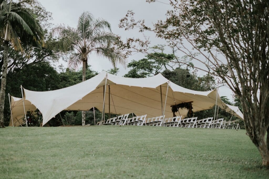 Stretch tent set up on the lawn for wedding ceremony
