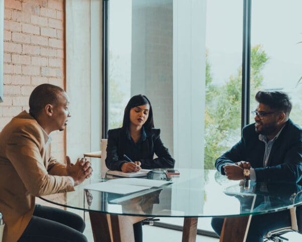 Members of PGPS Attorneys assisting client with legal paperwork in office setting.,