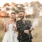 Bride and groom champagne spray