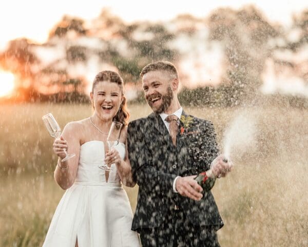 Bride and groom champagne spray