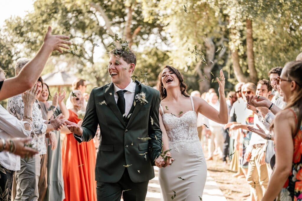Bride and groom exiting the aisle with confetti toss