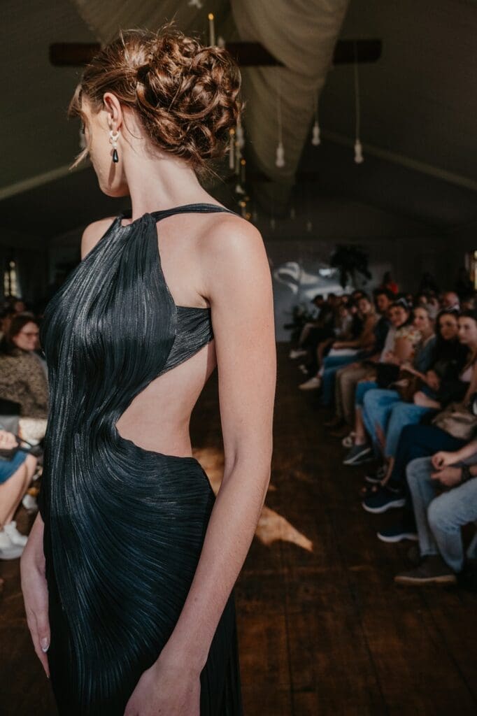 Stylish low bun hairstyle paired with black evening dress