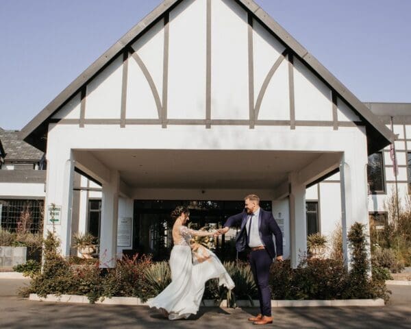 Couple dancing in front of ANEW Hotel Hilton