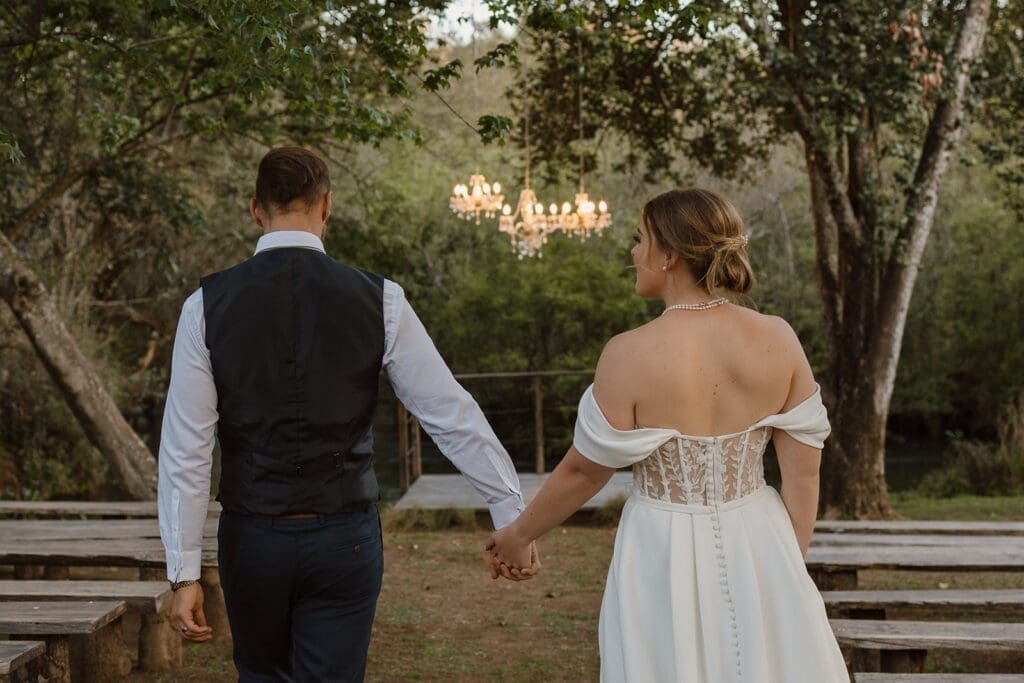 Bride and groom walking together towards the river deck
