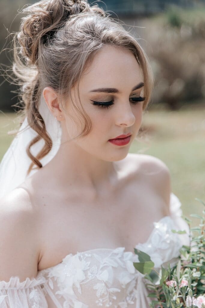 Elegant wedding updo hairstyle with soft curls framing face