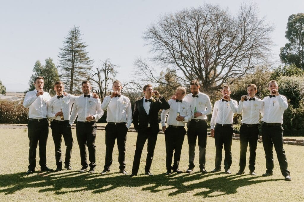 Groom standing with groomsmen on the lawn
