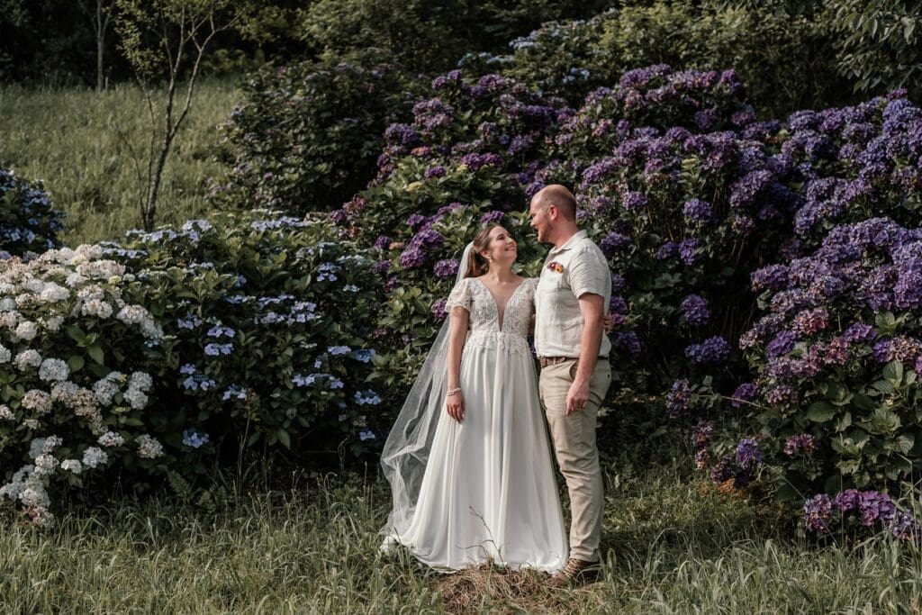 Bride and groom standing together in gardens at Bushwillow Park