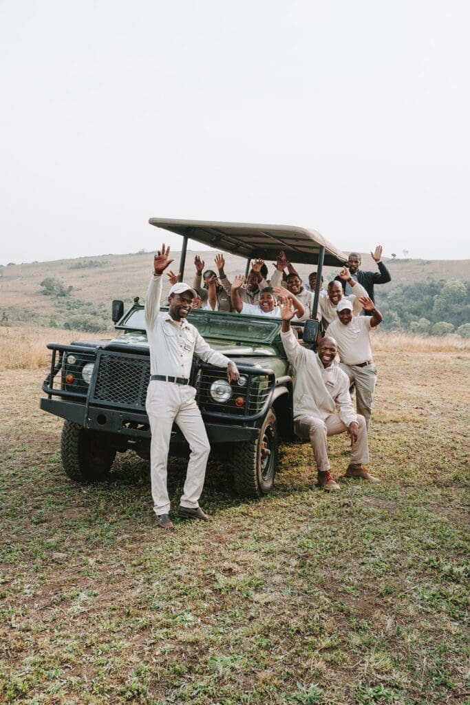 Staff at Duma Manzi Eco Lodge & Spa all packed into game vehicle waving
