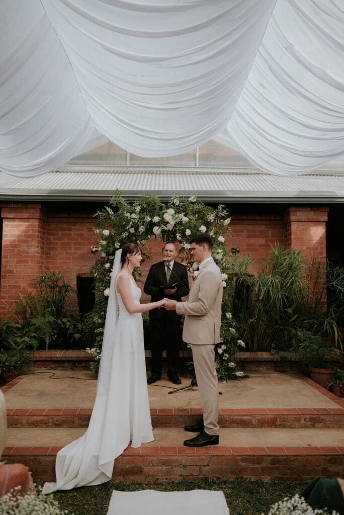 Bride and groom standing at front of ceremony in Atrium at Highgate Wine Estate