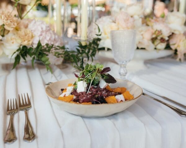Plated wedding meal on white table cloth by Hamblins Catering