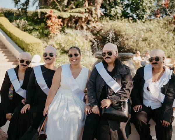 Bride with bride tribe dressed to impress as male bodyguards.