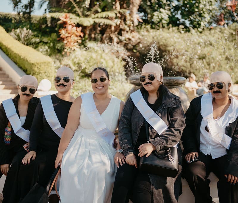 Bride with bride tribe dressed to impress as male bodyguards.